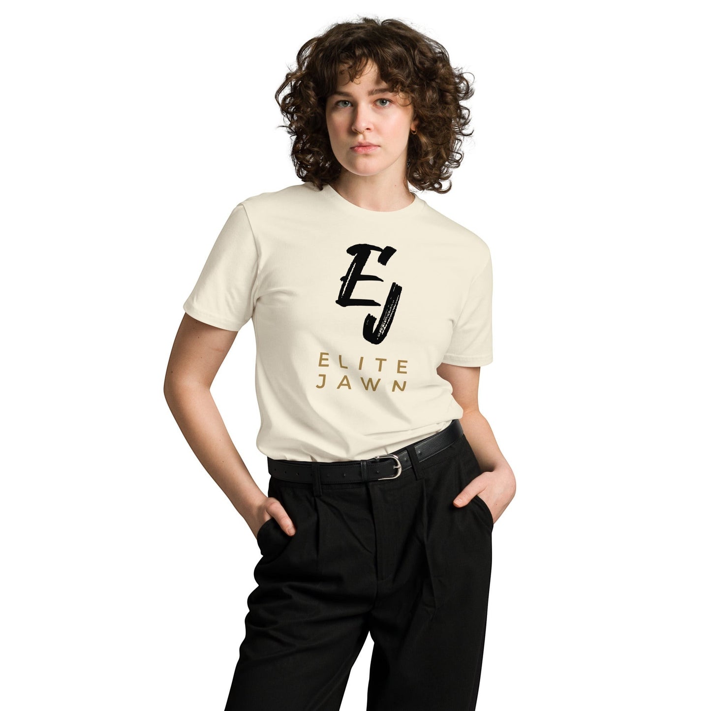 Elite Jawn cream 100% combed cotton crewneck t-shirt with black and gold logo. Model wears black pants and belt.